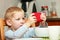 Funny dirty boy child kid taking photo with red mobile phone indoor