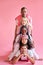 Funny diverse people in a row isolated over pink background