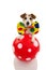 FUNNY DOG DRESSED AS A CLOWN WITH A RED BALL MAKING A TRICK. JACK RUSSELL COSTUME FOR CARNIVAL OR HALLOWEEN. ISOLATED ON WHITE