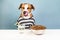 Funny dog in pajamas licking nose at breakfast table. Illustrative concept of puppy front of bowl of pet food