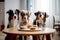 funny dogs sit at the table with a cake and candles