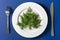 Funny edible Christmas tree made from dill and red caviar. Serving idea for celebration event. New Year food background top view.
