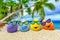 Funny eggs with sunglasses on exotic beach