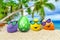 Funny eggs with sunglasses on exotic beach