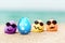 Funny eggs with sunglasses on exotic beach