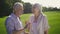 Funny elderly couple laughing at a joke outdoors