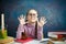 Funny Elementary Schoolgirl Show Palm at Desk