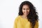 Funny, enthusiastic african american curly-haired girl in yellow autumn sweater silly winking and showing tongue with