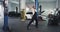 Funny and excited mechanic man dancing in front of the camera in a spacious service auto center