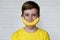 Funny face with banana smile. Angry boy. Young boy in yellow t-shirt holding banana with a smile