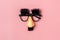 funny face - fake eyeglasses  nose and mustache on pink background Happy fools day concep