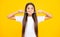 Funny face. Funny teen girl brush her teeth, dental healthy concept, isolated over yellow background. Healthy kids teeth