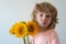 Funny face of son child with bouquet of sunflower flowers. Spring family holiday concept. Womens day. Children