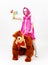 Funny fairy tale girl sitting upwards a man in costume of bear