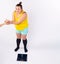 Funny fat girl dressed in house clothes who weighs herself and receives sweets as a gift, against the background of a