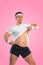 A funny fat man  on pink background. Obesity and eating disorder. Concept for dietetics and fitness advertising