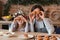 Funny father and little daughter fooling in kitchen, making cupcake eyes