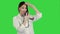 Funny female doctor playing with a stethoscope on a Green Screen, Chroma Key