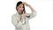 Funny female doctor playing with a stethoscope on white background