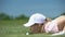 Funny female golf player blowing ball in hole, success strategy and cunning