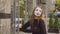 Funny female mime in street shows pantomime