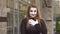 Funny female mime in street shows pantomime. Emotion abomination