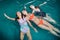 Funny female teenagers fooling around in the swimming pool laughing and enjoying their weekends