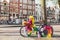 Funny festive bicycle on the street of Amsterdam, Netherlands. Vintage rusty bike with rainbow decoration