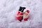 A funny figurine of a cheerful Santa Claus, who fell upside down into the snowdrifts.