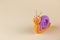 Funny figurine of a snail made of polymer clay. Copy space.