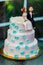 Funny figurines suite at a luxury wedding white cake