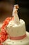 Funny figurines suite at a luxury wedding white cake decorated w