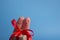 Funny fingers couple holding present gift box against blue background. Happy family celebrating concept for Christmas or New Years