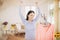 Funny foxy woman dancing with steamer iron. Housewife having fun while ironing clothes