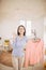 Funny foxy woman dancing with steamer iron. Housewife having fun while ironing clothes