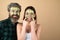 Funny friends with facial masks over isolated background. Funny couple has fun with a facial mask with Cucumber and aloe