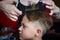 Funny Frowning Little Boy At The Hairdresser