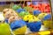 Funny fruits covered with chocolate icing and yellow and blue sweet powder in a window of a candy store