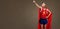 Funny funny cheerful man in a superhero costume in sports clothe