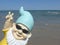 Funny garden gnome with sunglasses seaside makes peace sign