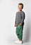 Funny giggling european little boy demonstrating sportswear in studio