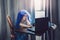 Funny girl in blue wig learning at distant remote virtual school online. Homeschooling class education for kids. Child using