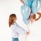 Funny girl with cats ears holding balloons in studio. Concept birthday