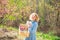 Funny girl hold rabbit on green field background. Pretty girl preparing for Easter.