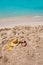 Funny girl playing buried in beach sand smiling sunglasses