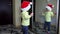 Funny girl put santa hat on head and jump in front of mirror. Careless childhood