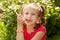 Funny girl in a red blouse eating ice cream