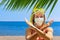 Funny girl in surgical face mask on sea beach