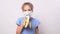 Funny girl teen in protective mask eats a banana.