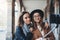 Funny girlfriends taking photo selfie on smartphone mobile. Blogger hug hipster travels in Barcelona. Holiday friendship concept